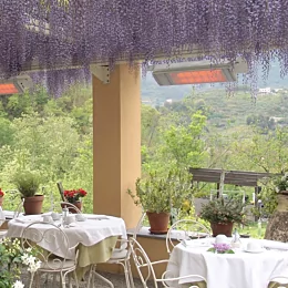 Heatscope Heaters Spot 2800W Radiant Heater wall-mounted on an outdoor restaurant terrace providing electric infrared heat.